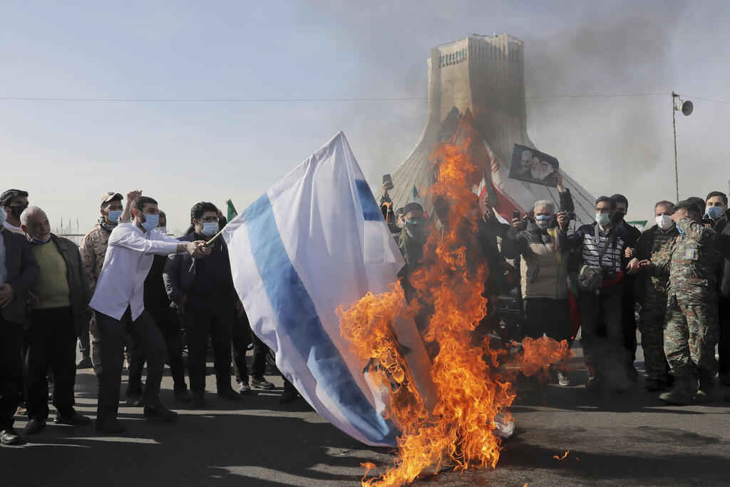 Iranians burn an Israeli flag during a rally in Tehran to mark the 42nd anniversary of the Islamic Revolution, Feb. 10, 2021 
