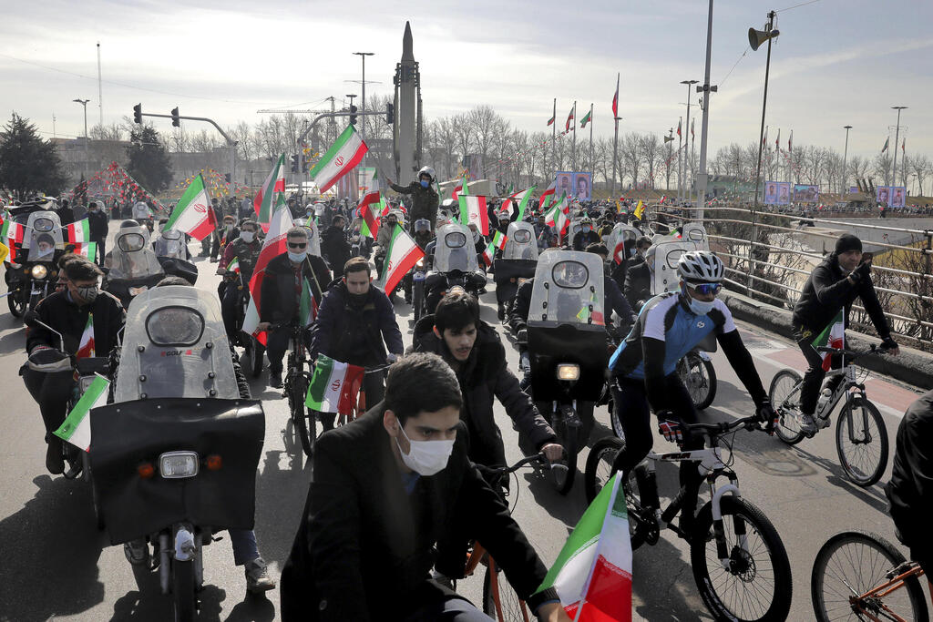 Iranians ride bicycles and motorbikes at a rally in Tehran to mark the 42nd anniversary of the Islamic Revolution, Feb. 10, 2021 