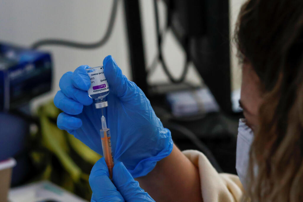A dose of AstraZeneca vaccine is prepared at a COVID-19 vaccination centre in the Odeon Luxe Cinema in Maidstone, Britain 