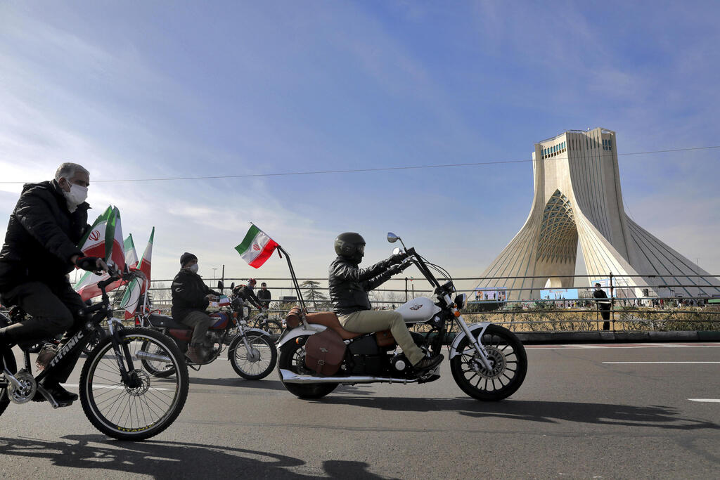 Iranians ride bicycles and motorbikes at a rally in Tehran to mark the 42nd anniversary of the Islamic Revolution, Feb. 10, 2021 