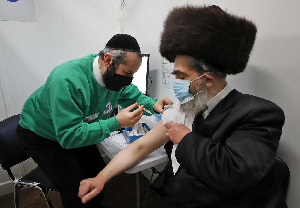 Rabbi Bieberfeld is administered a dose of the AstraZeneca coronavirus vaccine in central London