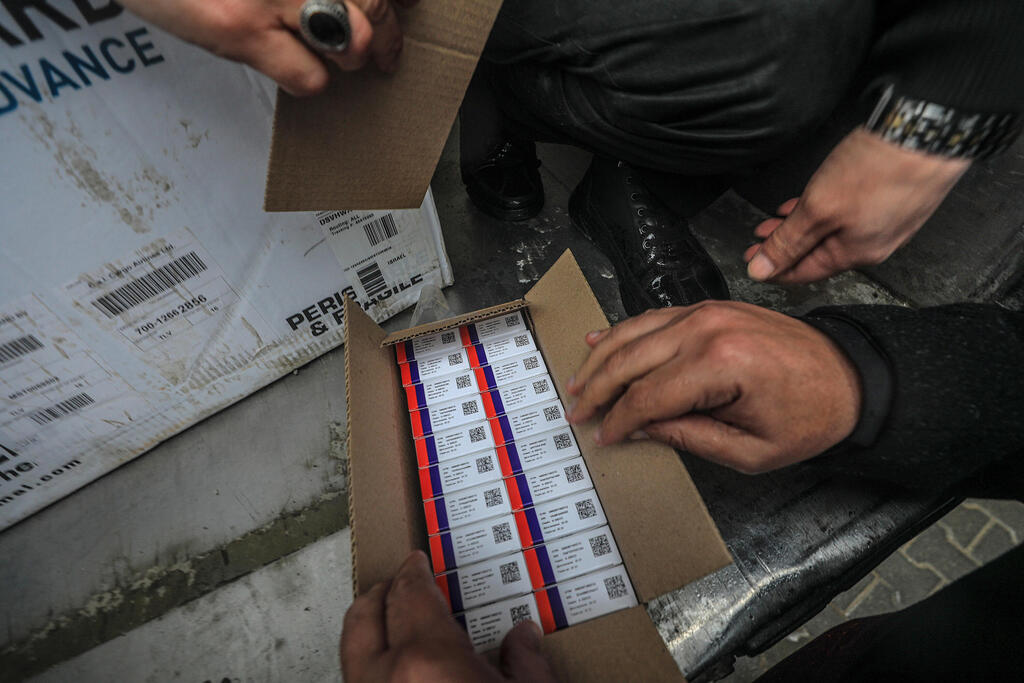 Palestinian Health employees receive Covid-19 vaccines after a shipment