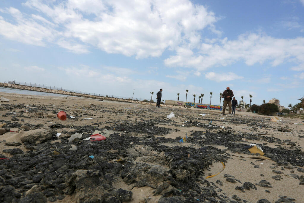 Tar is seen on the beach in the aftermath of an oil spill that drenched much of the Mediterranean, in Tyre nature reserve, Lebanon 