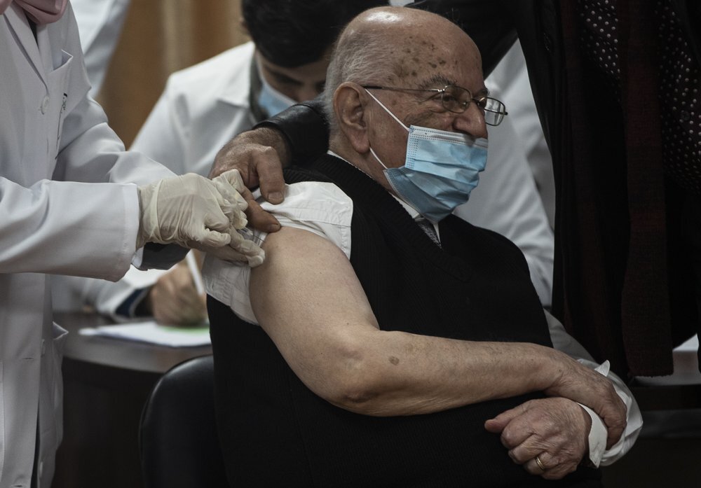 Former Palestinian Health Minister Riyad al-Zanoun receives a shot of the Russian-made Sputnik V coronavirus vaccine, in Gaza City 