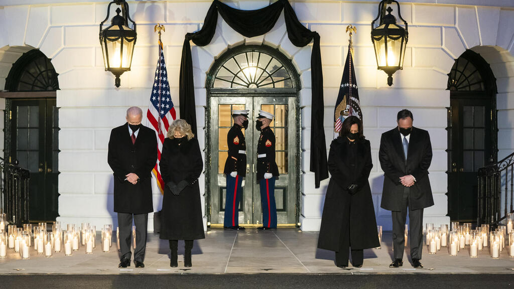 US President Joseph Biden (L), First Lady Jill Biden (C-L), Vice President Kamala Harris (C-R) and Second Gentleman Doug Emhoff (R) hold a moment of silence for the 500,000 Americans who have died from the Covid pandemic