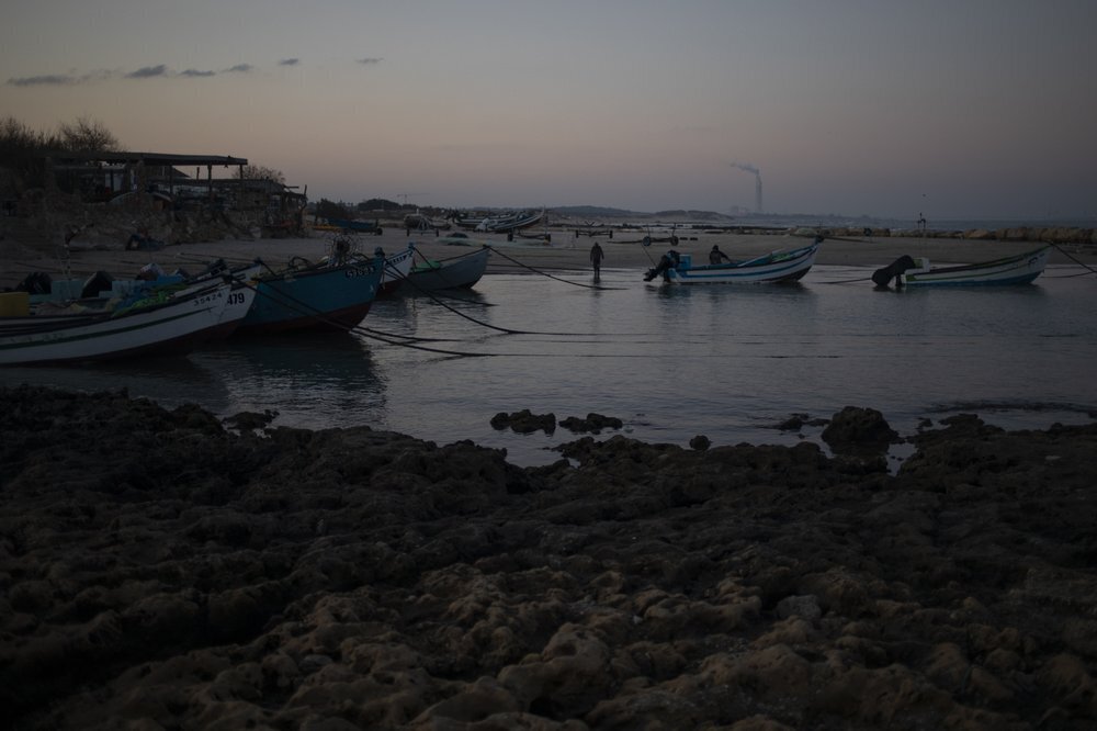 Fishermen unload their nets after returning from a fishing trip on the Mediterranean Sea, in the Israeli Arab village of Jisr al-Zarqa 