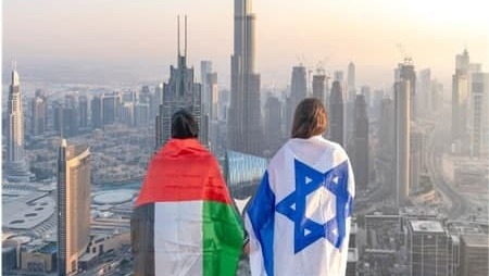 GIrls draped in flags of Israel and the UAE in Dubai 