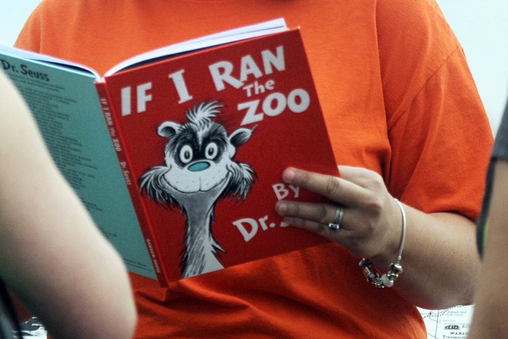 Courtney Keating, education coordinator of The Literacy Center in Evansville, Ind., reads "If I Ran the Zoo," By Dr. Seuss, to passersby during an event to promote literacy along the Evansville Riverfront. 