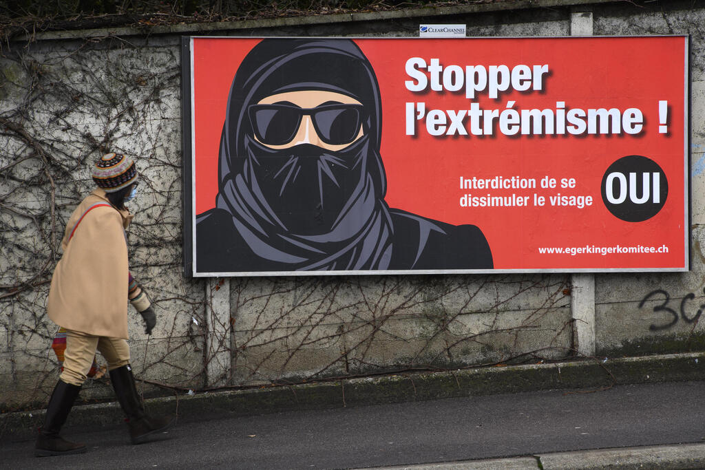 A torn poster of the initiative 'Yes to the burqa-ban' is seen in Lausanne, Switzerland 