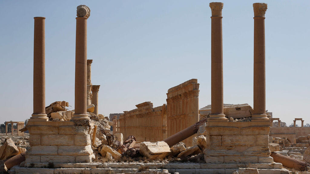 A picture shows a partial view of the damaged tetrapylon, a 16-columned structure that marked one end of Palmyra's colonnade, in Syria's Roman-era ancient city of Palmyra