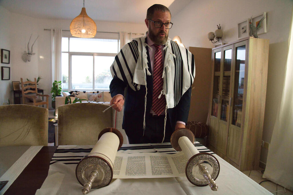 Alex Peterfreund, a co-founder of Dubai's Jewish community and its cantor, prepares to read from the Torah in Dubai 