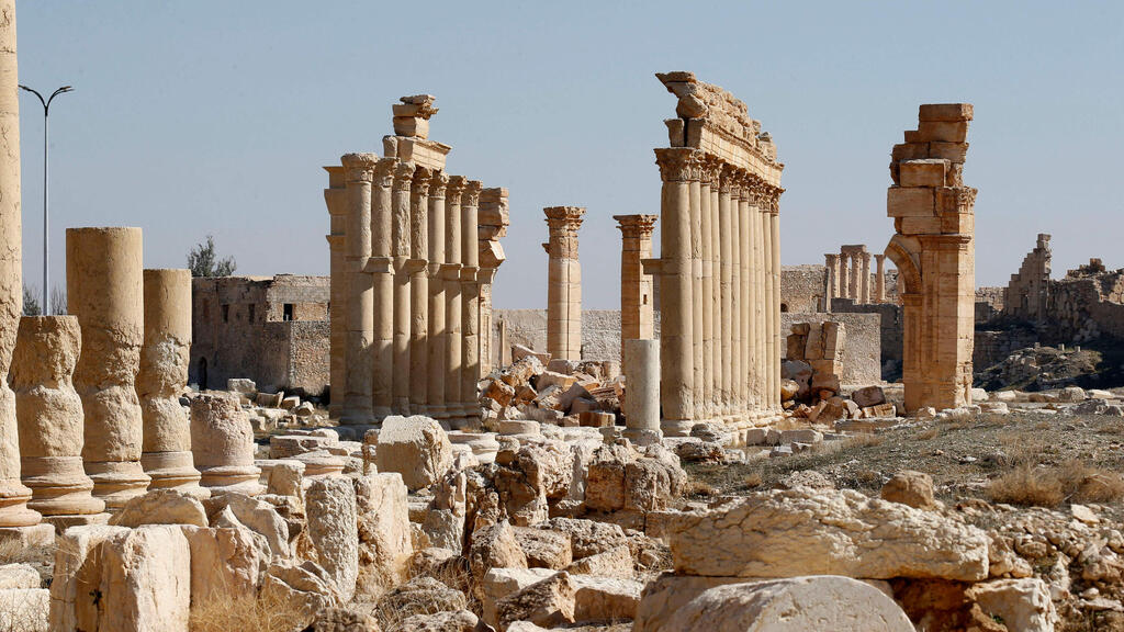 picture shows the damaged Arch of Triumph and surrounding columns in Syria's Roman-era ancient city of Palmyra
