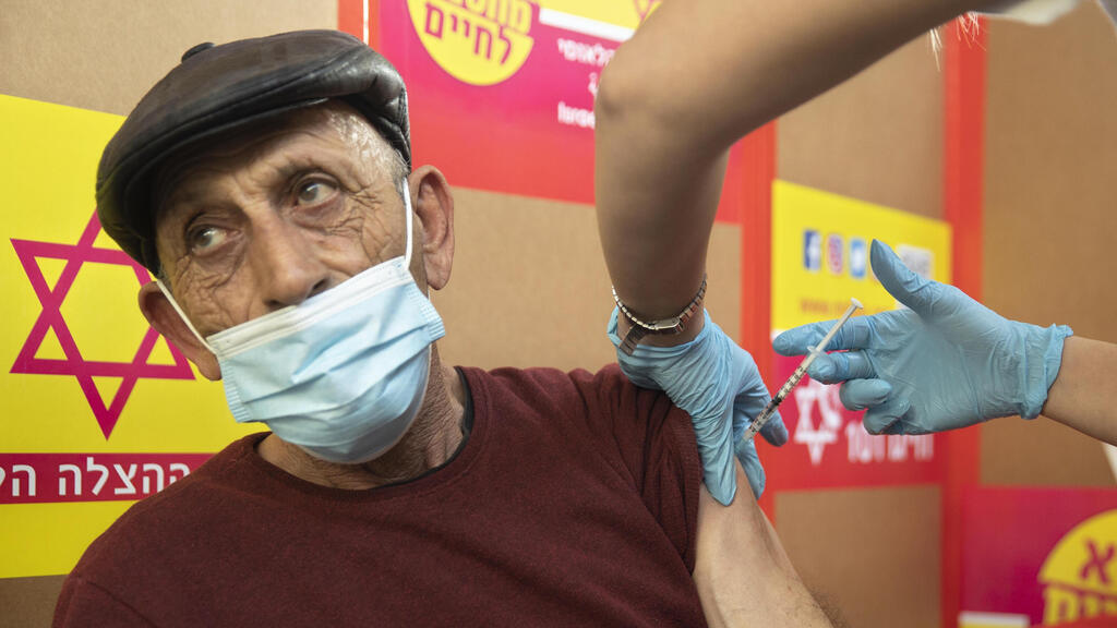 A Palestinian worker receives his coronavirus vaccine from Israel earlier this week 