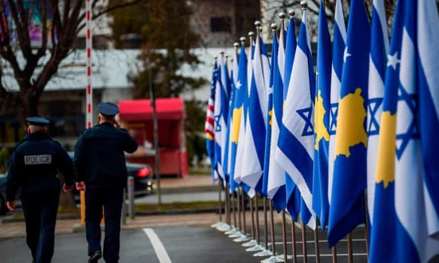 Police officers walk past Kosovan and Israeli flags displayed during a ceremony in Pristina in February after the countries established diplomatic ties 