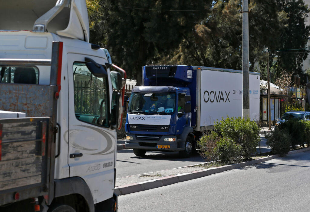 A refrigerated truck loaded with the first delivery of coronavirus vaccine via the United Nations Covax program supporting poorer areas, drives toward the West Bank city of Ramallah, on March 17, 2021 