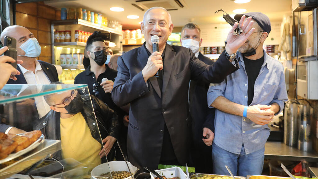 Benjamin Netanyahu campaigns at Mahane Yehuda market in Jerusalem in a last-minute effort to win support  