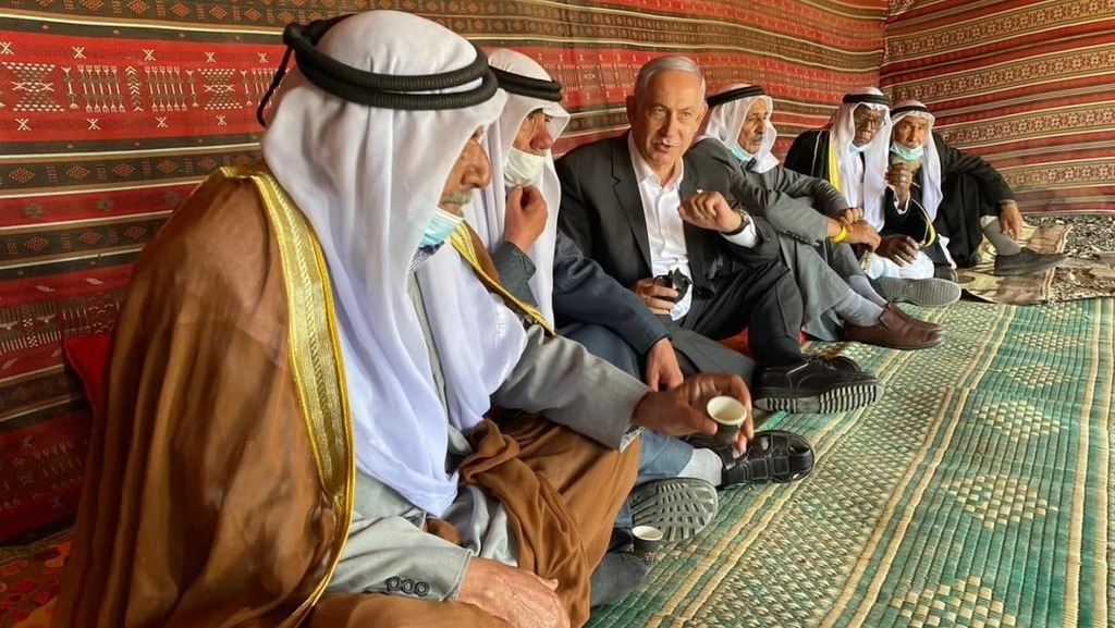 Prime Minister Benjamin Netanyahu shares coffee with Bedouin dignitaries in the village of Tirabin al-Sana in the Negev Desert during his campaign for re-election 