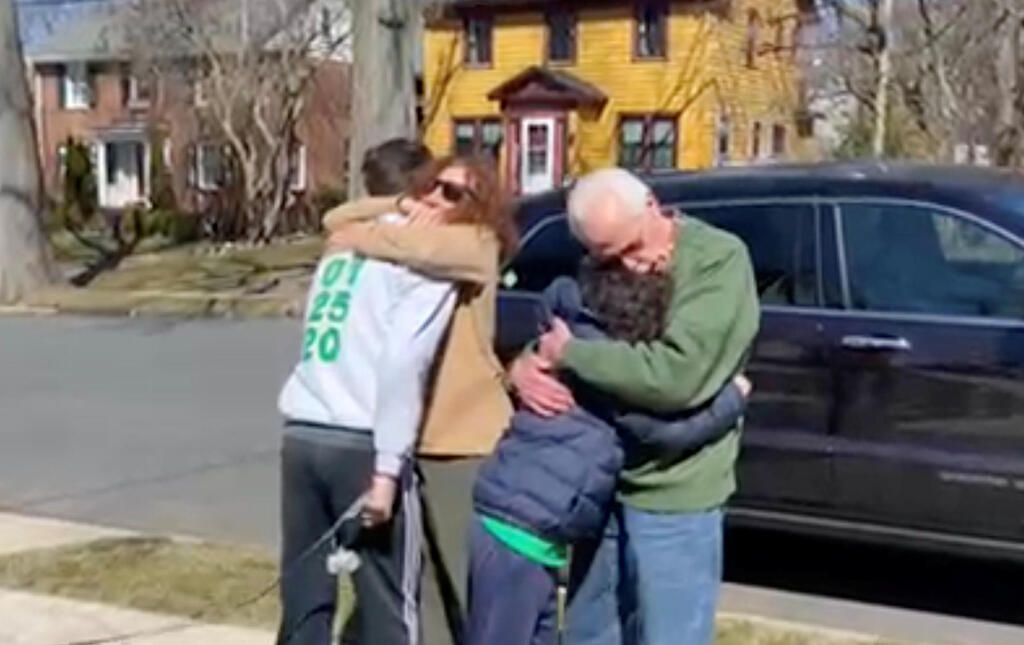 Esther and Bob Greenberg hug their grandsons Noah and Alex Barkin outside the children’s home in Maplewood, New Jersey, March 2021 