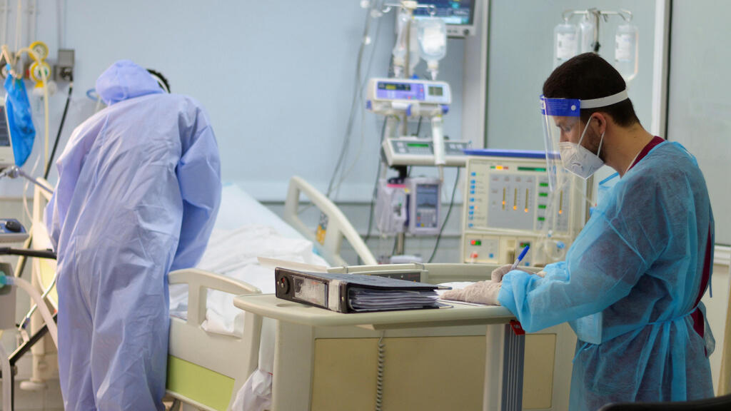 Medical staff members assist a patient suffering from the coronavirus disease (COVID-19), in an intensive care unit at a hospital in Amman, Jordan