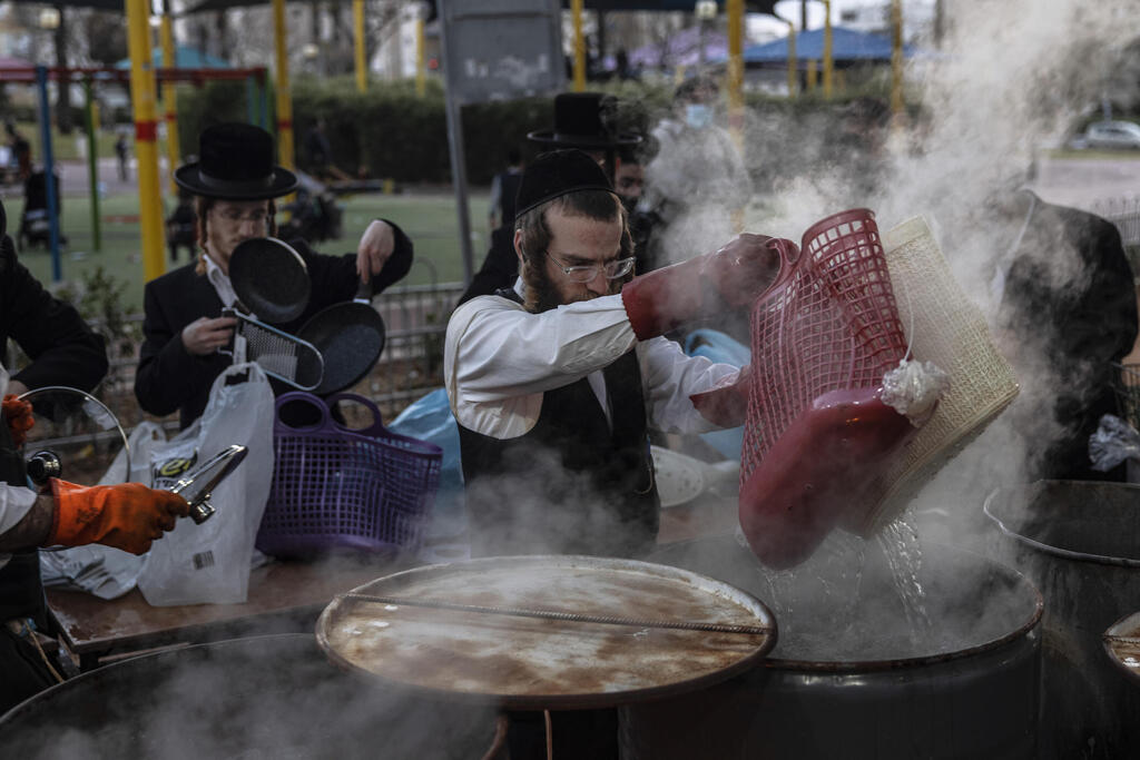 An ultra-Orthodox man dips prepares for Passover in Ashdod ahead of the holiday that begins Saturday 