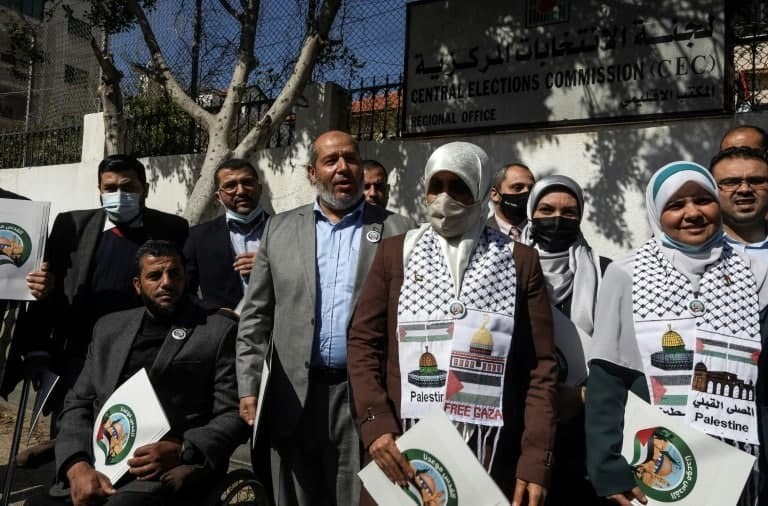 Senior Hamas official Khalil al-Haya poses with supporters outside the electoral commission headquarters in Gaza City
