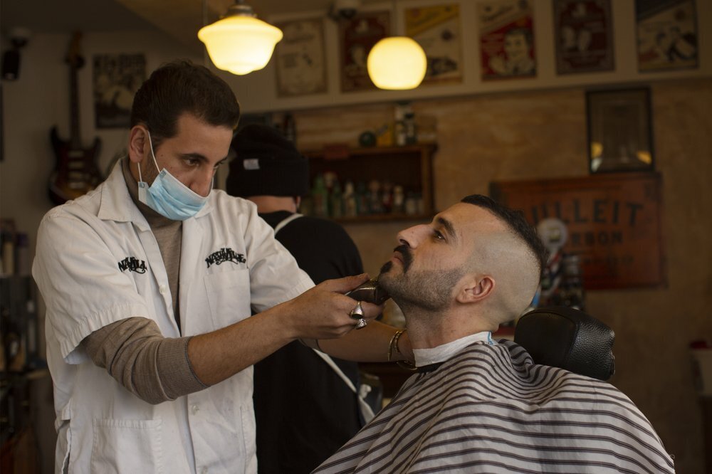 a customer at Nashville Barber Shop gets a shave after coronavirus restrictions were eased in Jerusalem 