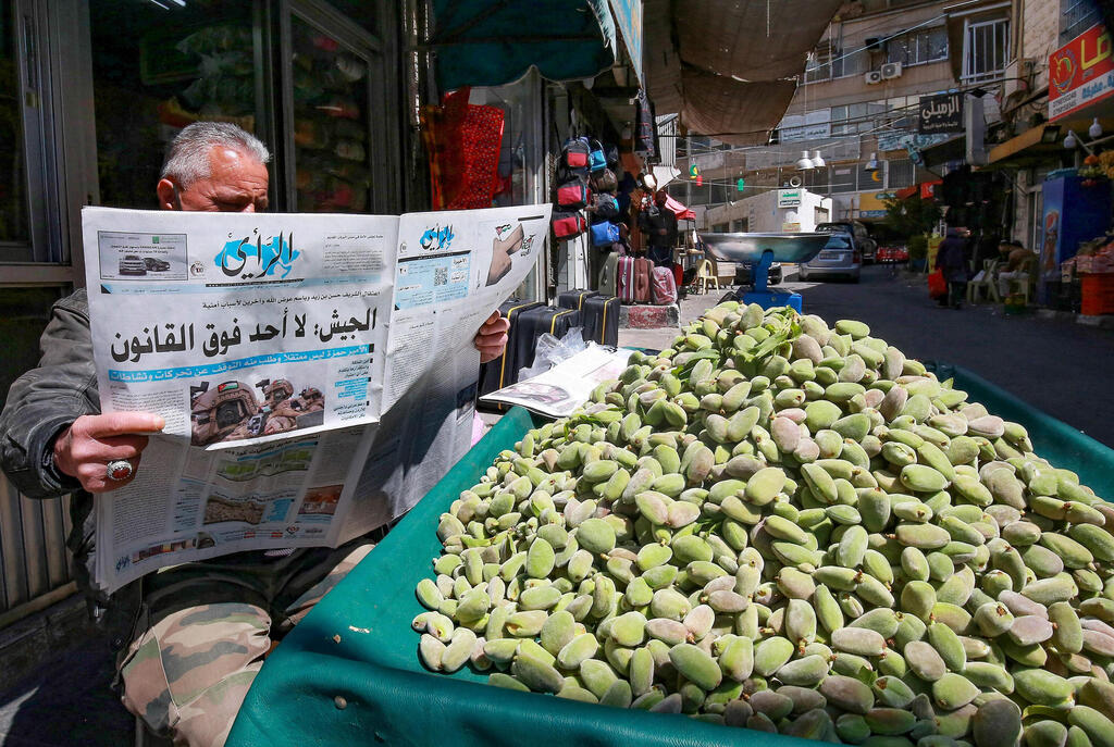 Man in Jordan's capital of Amman reads about the attempted coup 