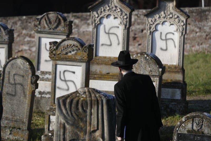 Strasbourg chief Rabbi Harold Abraham Weill looks at vandalized tombs in the Jewish cemetery of Westhoffen, west of the city of Strasbourg, eastern France 