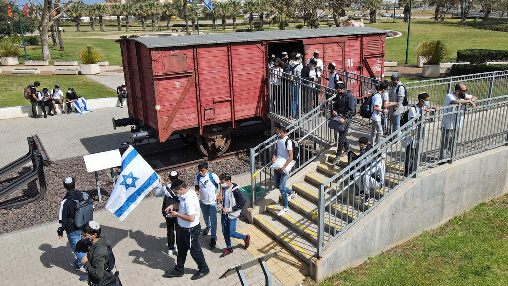 Students and teachers of Bar Ilan School visit an authentic German train, that transported Jews to extermination camps, on the Holocaust Remembrance Day in the Israeli city of Netanya
