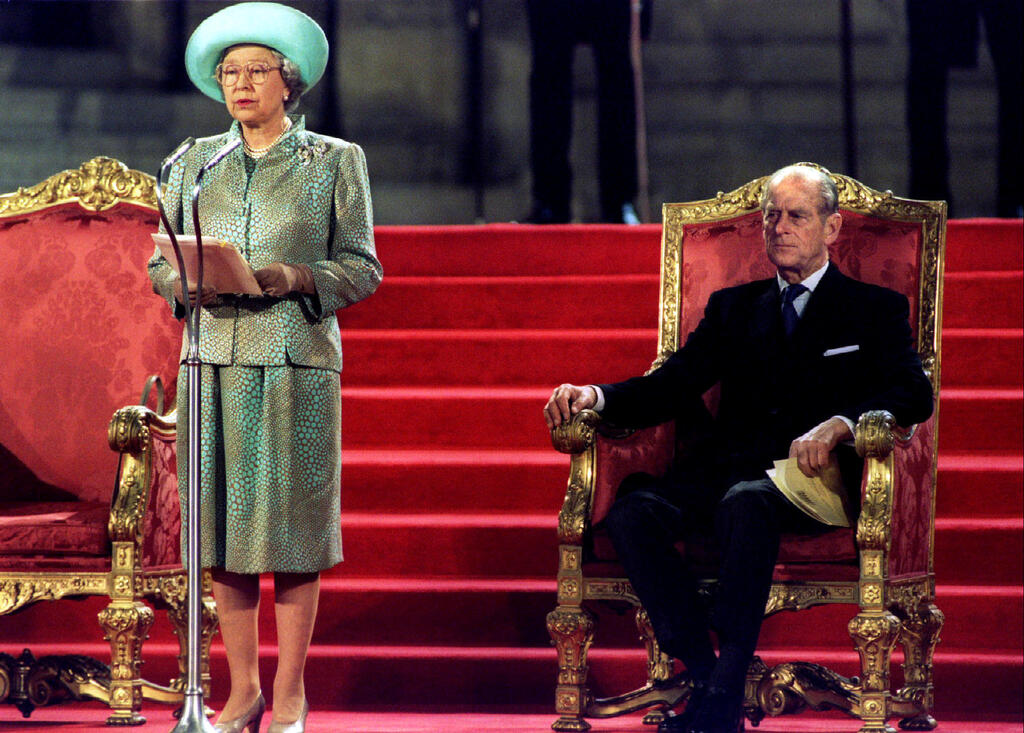 Prince Philip watches as Queen Elizabeth delivers an address to both houses of parliament at the Palace of Westminster May 5, 1995 