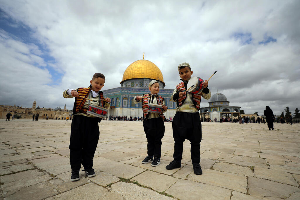 Muslim kids play music at Temple Mount in Jerusalem's Old City during preparation for the holy Muslim month of Ramadan as COVID-19 restrictions ease around Israel April 10, 2021