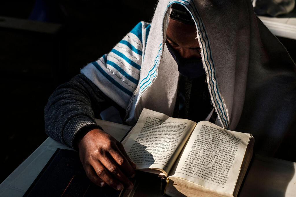 A member of the Ethiopian Jewish community attends a religious service at the synagogue of the community in the city of Gondar, Ethiopia 