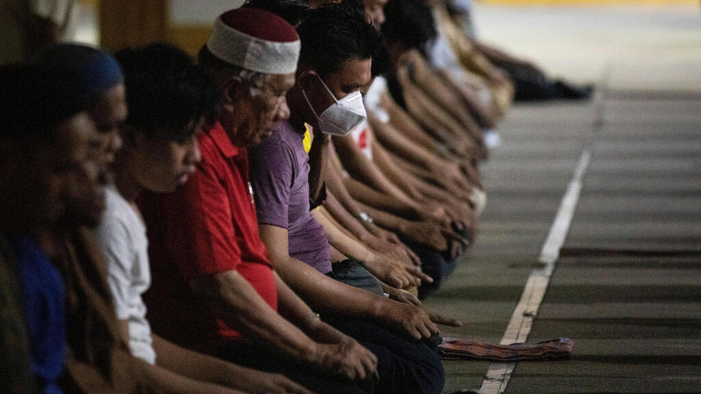 Filipino Muslim men attend prayers on the first day of Ramadan, amid the coronavirus disease (COVID-19) pandemic, at Golden Mosque in Quiapo, Manila, Philippines
