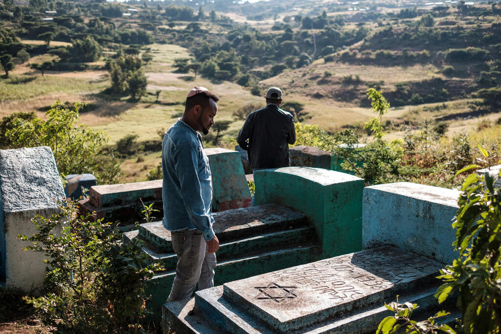 Sitotaw Alene (R) and Adamu Mengistu, leaders of the Ethiopian Jewish community, visit the cemetery of the community in the outskirts of the city of Gondar, Ethiopia 