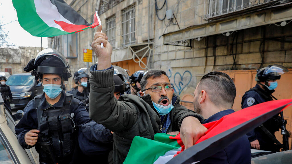  Palestinian demonstrator is pushed by an Israeli policeman during a protest against visits by Israeli settlers, in Hebron