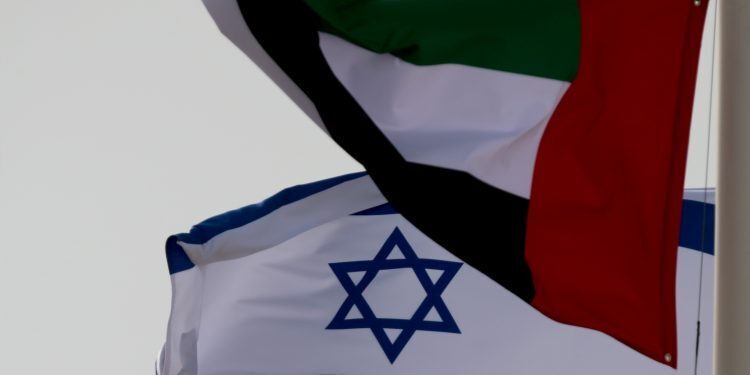 Emirati and Israeli flags fly upon the arrival of Israeli and U.S. delegates at Abu Dhabi International Airport, in Abu Dhabi, United Arab Emirates Aug. 31, 2020