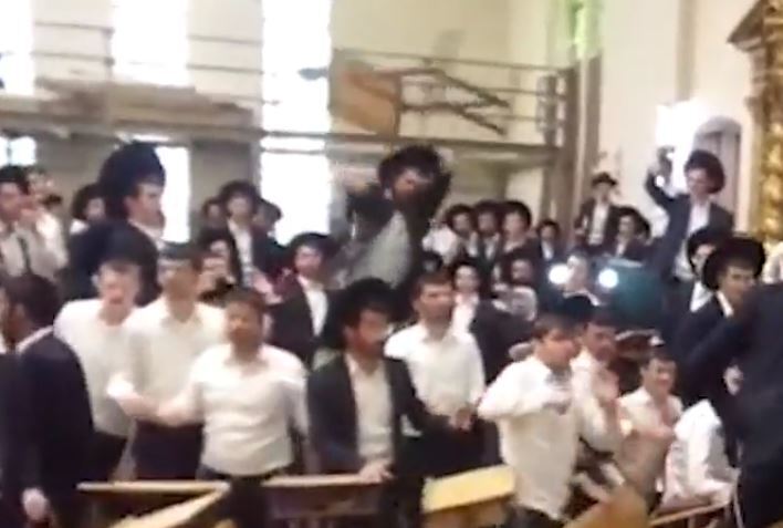 A chair flies during clashes at the yeshiva 