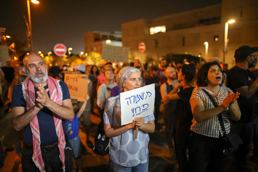 protesters hold a demonstration against right wing groups taking over houses in Jaffa