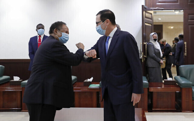 Former US Treasury Secretary Steven Mnuchin (L) and Sudanese Justice Minister Nasredeen Abdulbari sign the Abraham Accords in Sudan in January 2021