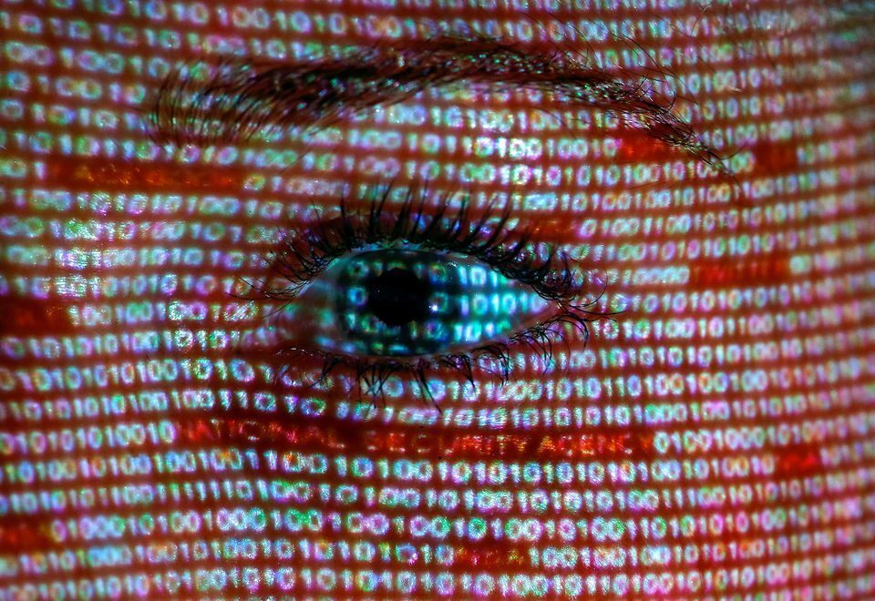 An illustration picture shows a projection of text on the face of a woman in Berlin, June 12, 2013