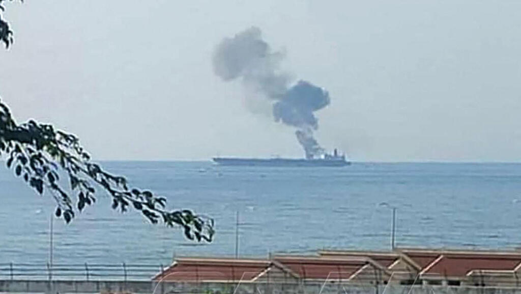 A handout picture released by the official Syrian Arab News Agency (SANA) on April 24, 2021, shows smoke billowing from a tanker off the coast of the western Syrian city of Baniyas 