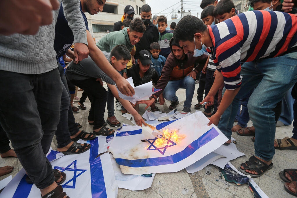 Palestinians in Gaza burn Israeli flags during a protest Saturday over tensions in Jerusalem 