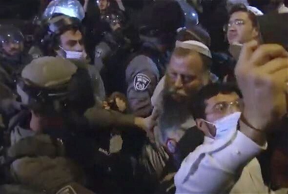 Lehava leader Bentzi Gopstein scuffles with police as they break up his extreme-right rally in Jerusalem last week 