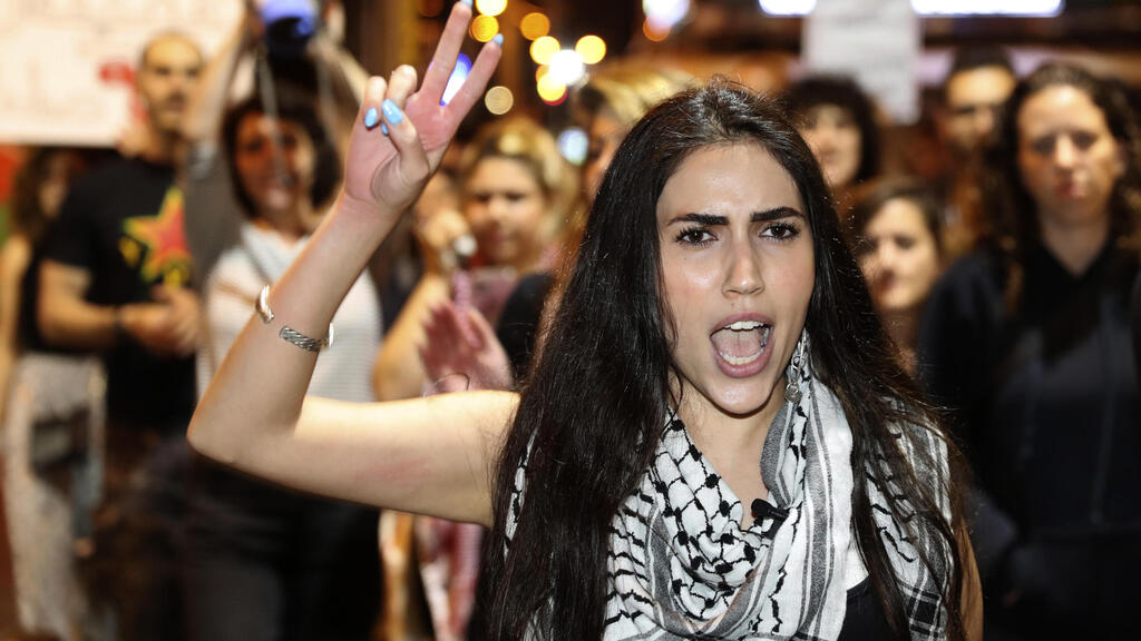 An Arab woman shouts slogans against Jewish nationalist religious groups that are buying up property in the Arab neighborhood of Jaffa, in Tel Aviv, Israel, Saturday, April 24, 2021 