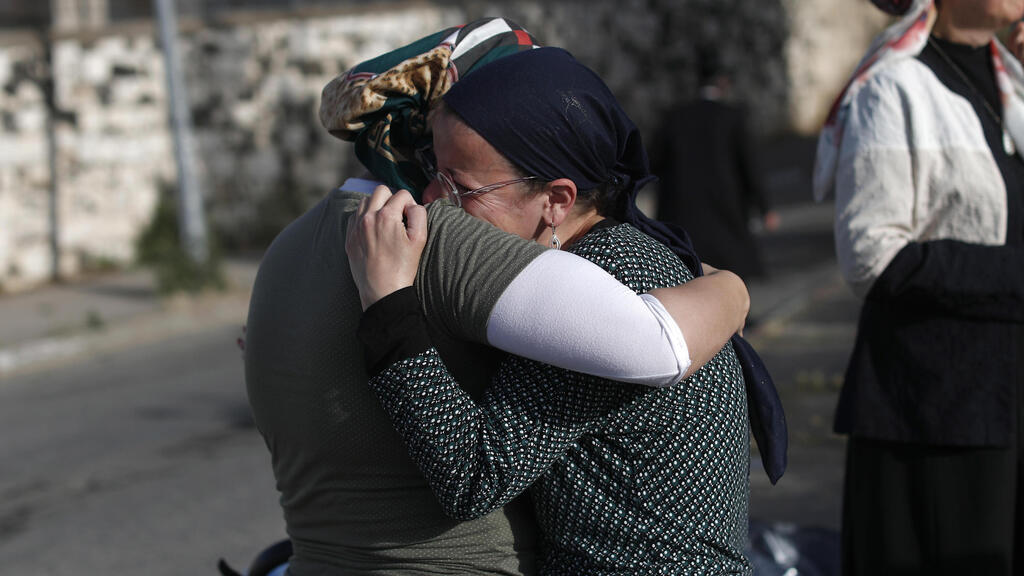 Family members mourning the loss of a loved one in the Meron stampede 