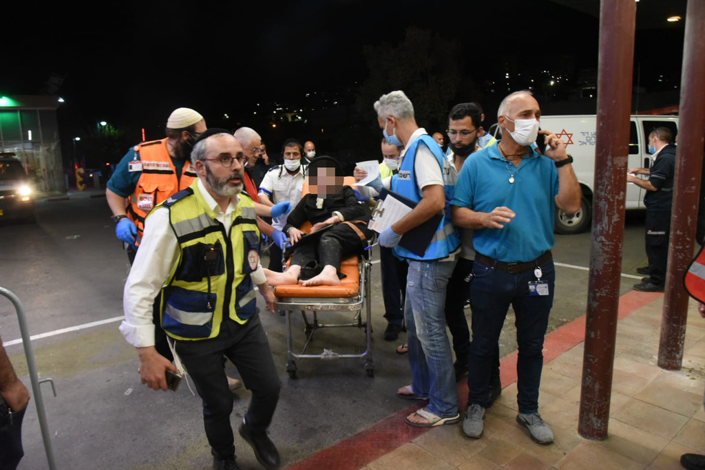 First responders evacuate a reveler hurt in the Mount Meron stampede to Ziv Medical Center in Safed 
