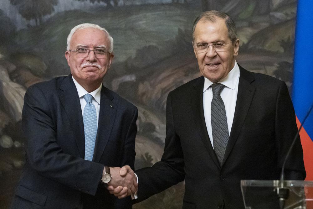 Russian Foreign Minister Sergey Lavrov, right, and Palestinian Foreign Minister Riyad Al-Maliki shake hands as they leave a joint news conference following their talks in Moscow, Russia 