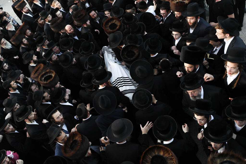 Ultra-Orthodox mourners attend the funeral in Jerusalem for one of the victims of the crush at Mount Meron, April 30, 2021 