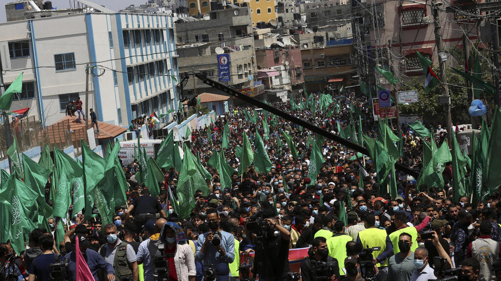 Hamas supporters wave green Islamic flags during a rally in solidarity with fellow Palestinians in Jerusalem 