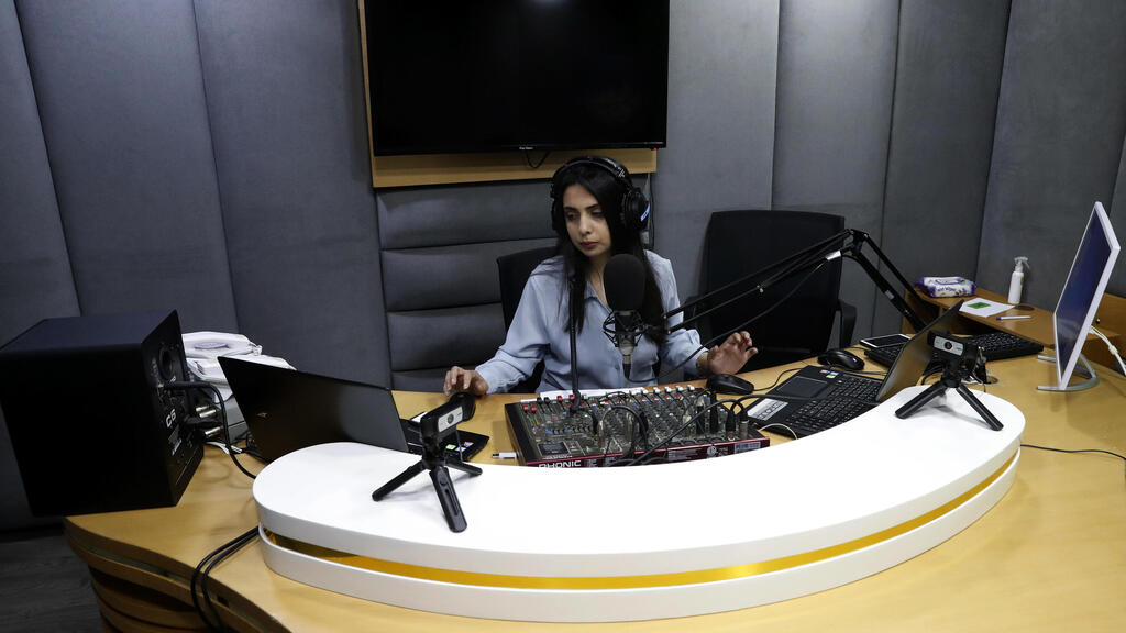 Palestinian journalist Rewaa Mershid works at the studio of ZMN FM radio station in Gaza City 